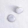 Side view with a pair of 16mm round white marble stud earrings