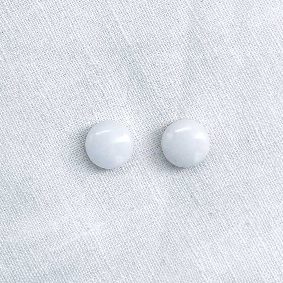 Front view of a pair of white marble stud earrings