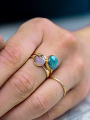 Layered gold fill rings made with two sizes of round natural stone worn on a hand