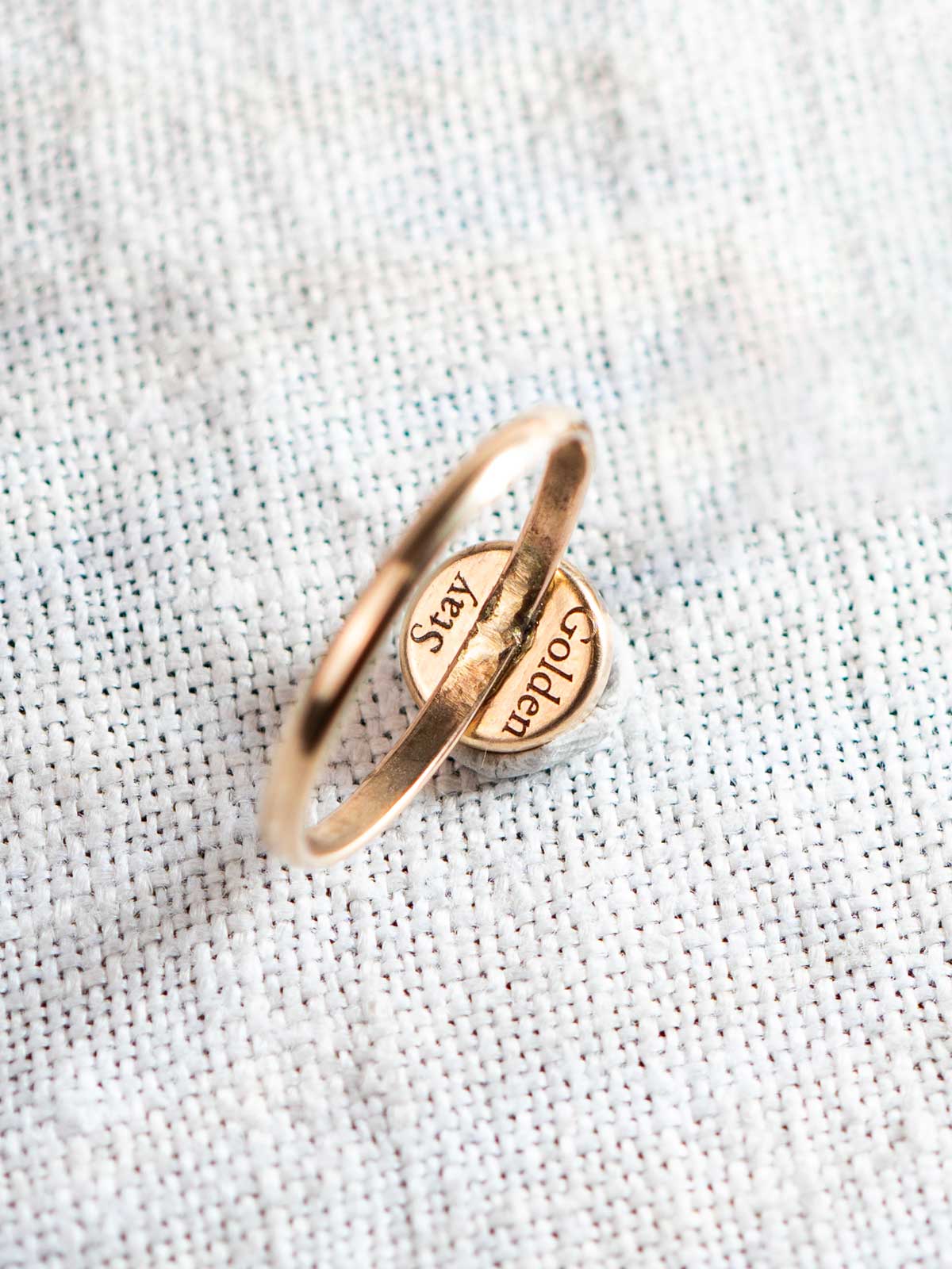 Gold fill ring with text on the back of the stone setting that reads "Stay Golden"