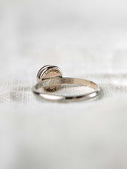 Sterling silver ring with a round stone engraved on the back