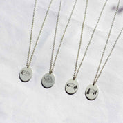 four voyager charm necklaces with mountain peak designs.  Grand tetons,  Denali, Pikes Peak, and Mount Mitchell charms pictured