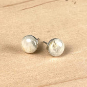 Pair of round sterling silver stud earrings set with a natural stone and custom engraved on the edge