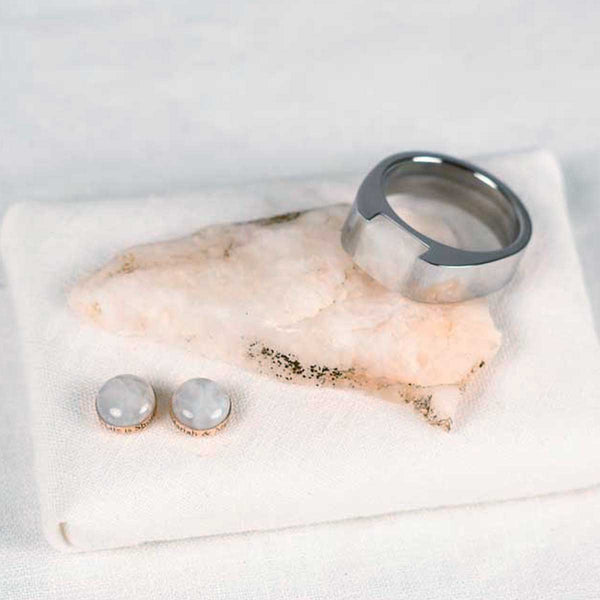Silver color stainless steel ring and sterling silver stone stud earrings with the chunk of rock they were made from