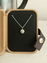 Sterling silver necklace with a natural granite stone pendant in an open kraft jewelry box 