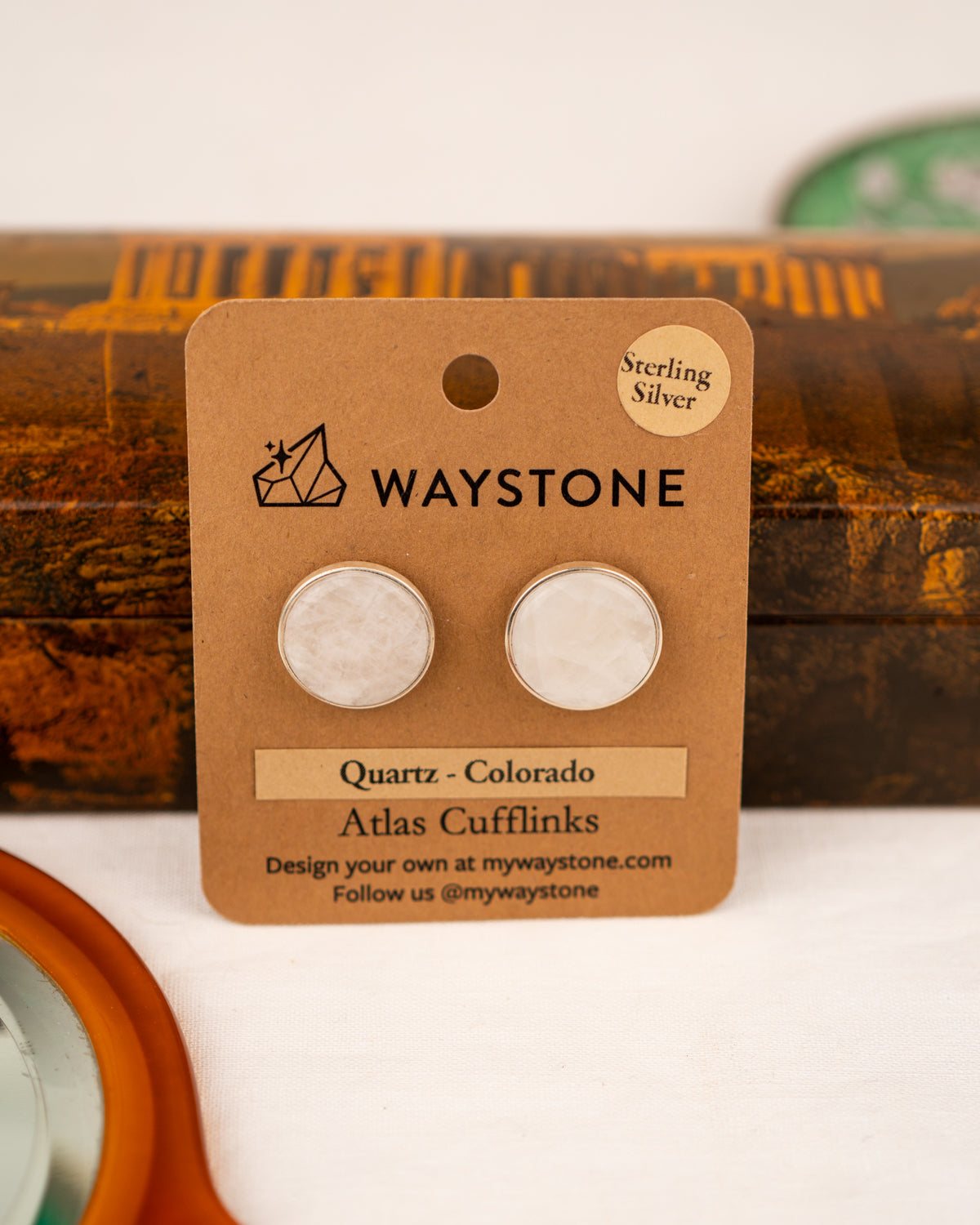 White colored milky quartz set into a sterling silver cufflinks on a Waystone branded card