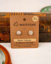 White colored milky quartz earrings on a Waystone branded card