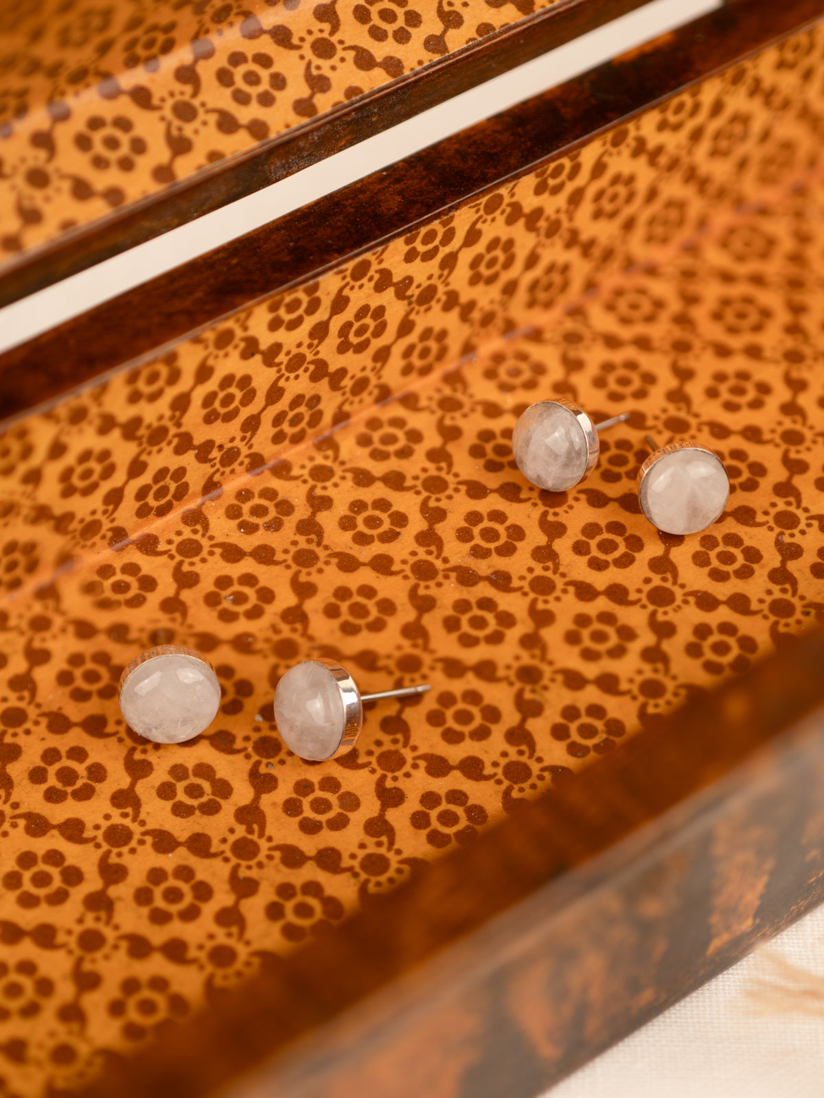 Two sets of white colored milky quartz in an orange box