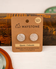 White colored milky quartz earrings on a Waystone branded card