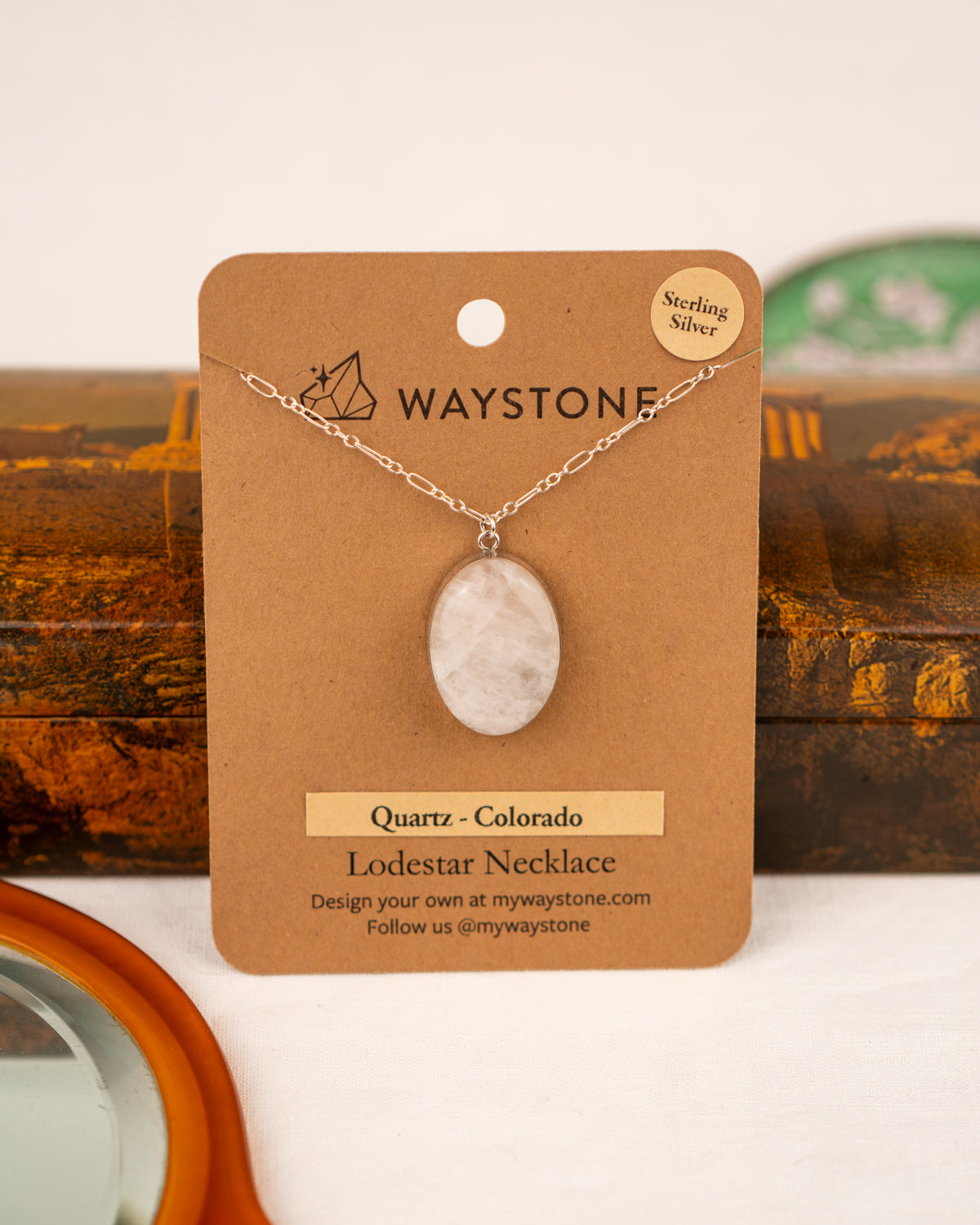 White colored milky quartz set into a sterling silver pendant on a Waystone branded card