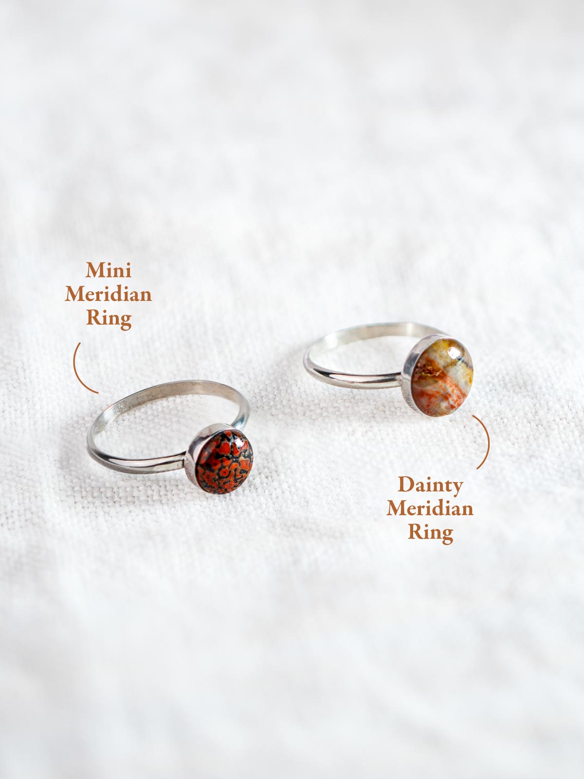 Two silver rings set with circular rocks in different sizes, the smaller Mini and the larger Dainty