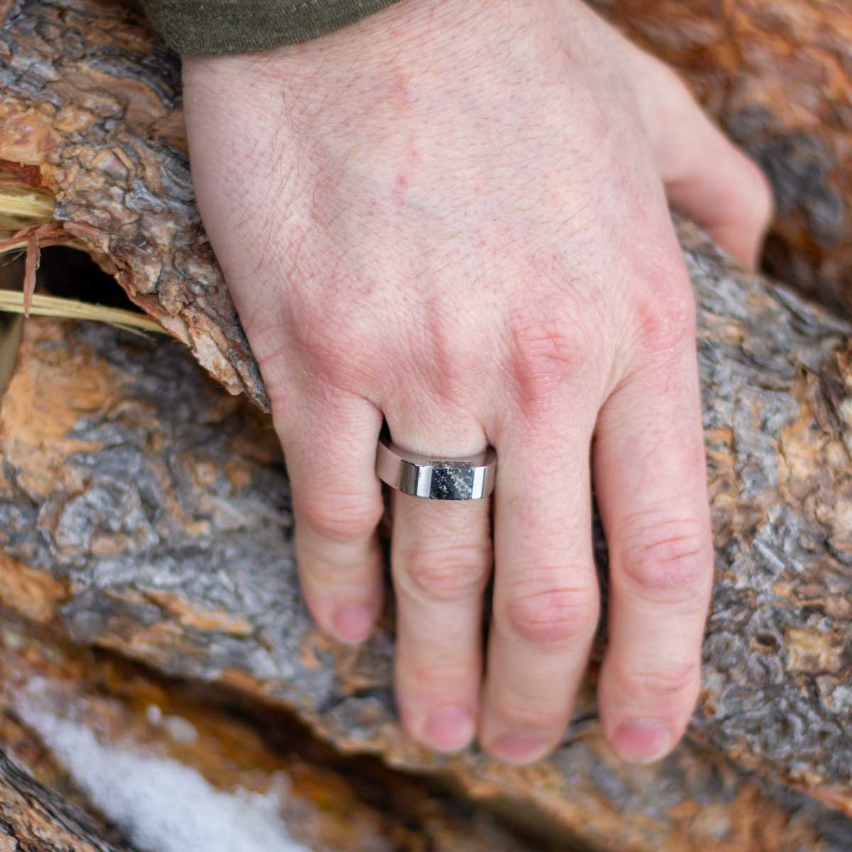 Man wearing stainless steel signet ring customized with a natural granite stone