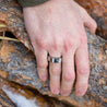 Man wearing stainless steel signet ring customized with a natural granite stone