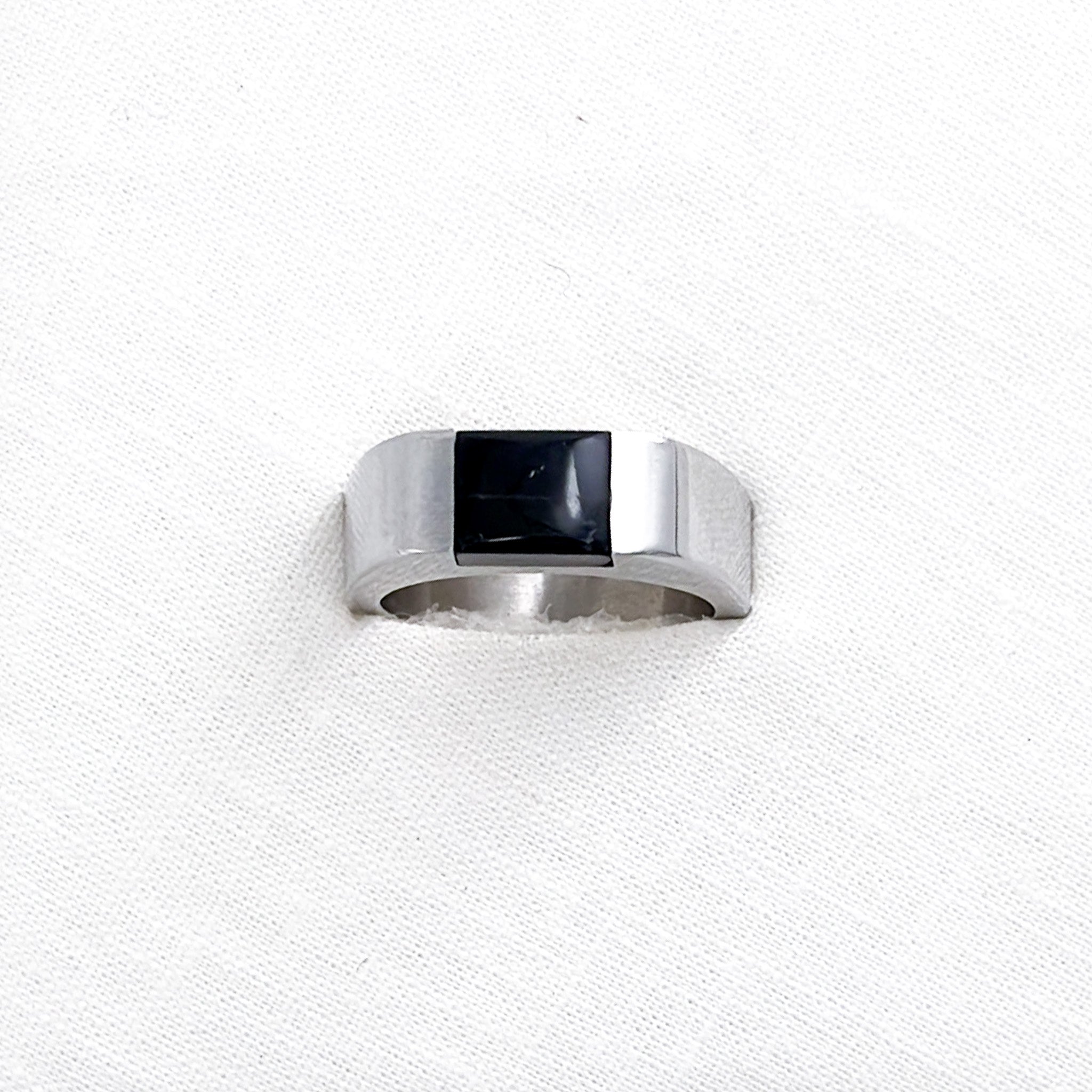 A stainless steel signet ring with an inset black onyx stone
