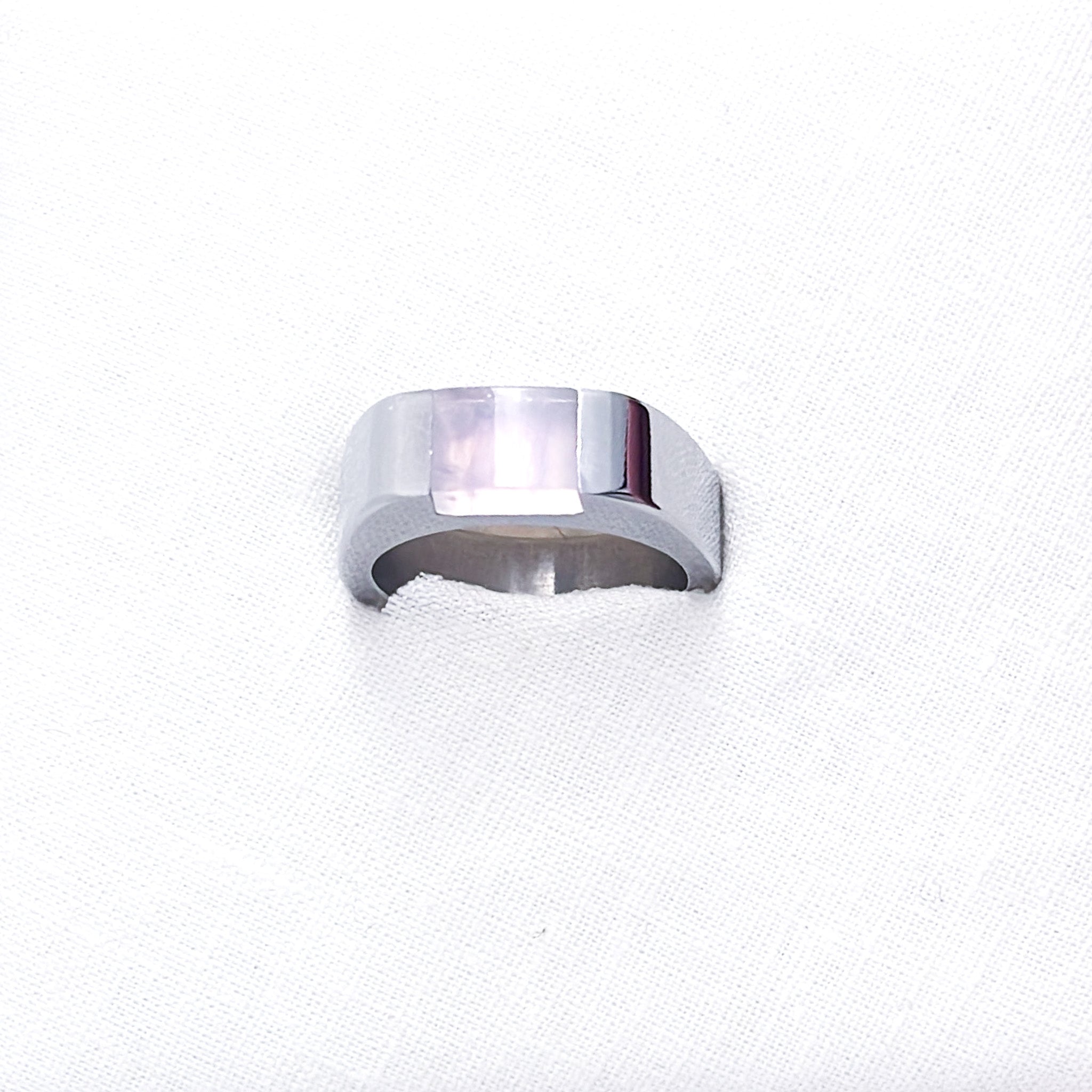 A stainless steel signet ring with an inset rose quartz stone