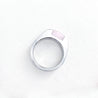 A stainless steel signet ring with an inset rose quartz stone