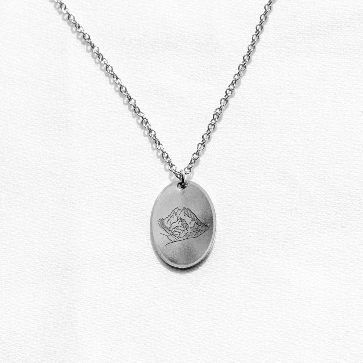 Sterling silver charm with an engraving of Mount Denali