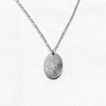 Sterling silver charm necklace with an engraving of the state of Texas