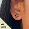 Close-up of a person wearing a silver stud earring set with black and white speckled granite. The text "you send the stone" is in the corner.