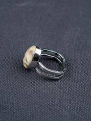 Side profile of the Zebra stone statement ring with a polished oval stone featuring natural brown and cream striations, set in a handcrafted metal bezel with a double-banded shank.