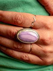 Sterling silver Tiffany stone ring photographed on the middle finger of a person