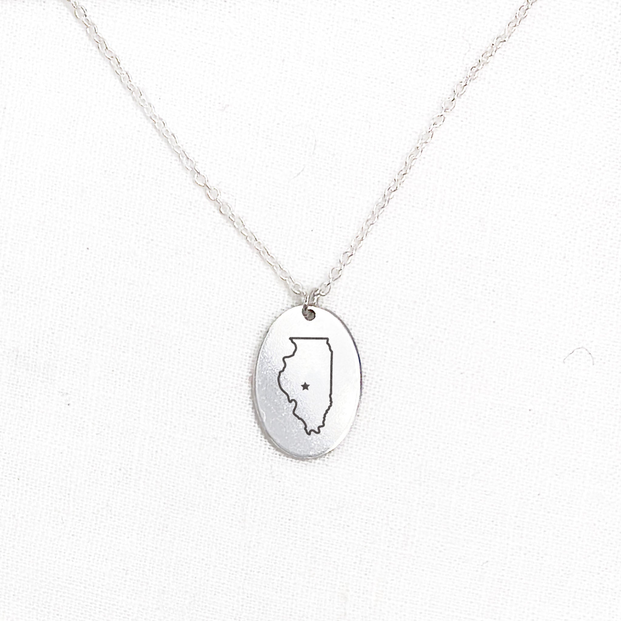 a voyager charm necklace with an Illinois artwork engraving