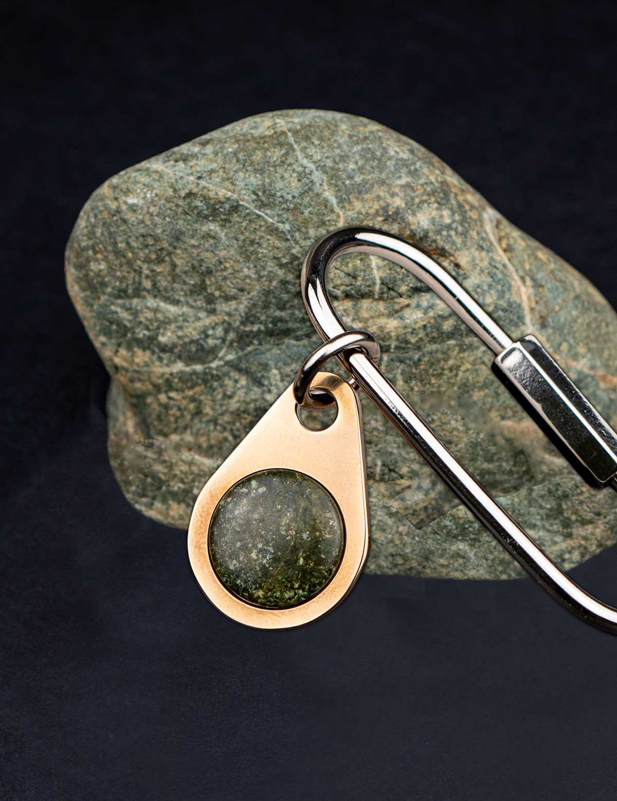 Champagne color key tag set with a green stone on a screw lock key ring with the stone it was made from