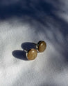 Pair of green stone stud earrings with a sterling silver setting