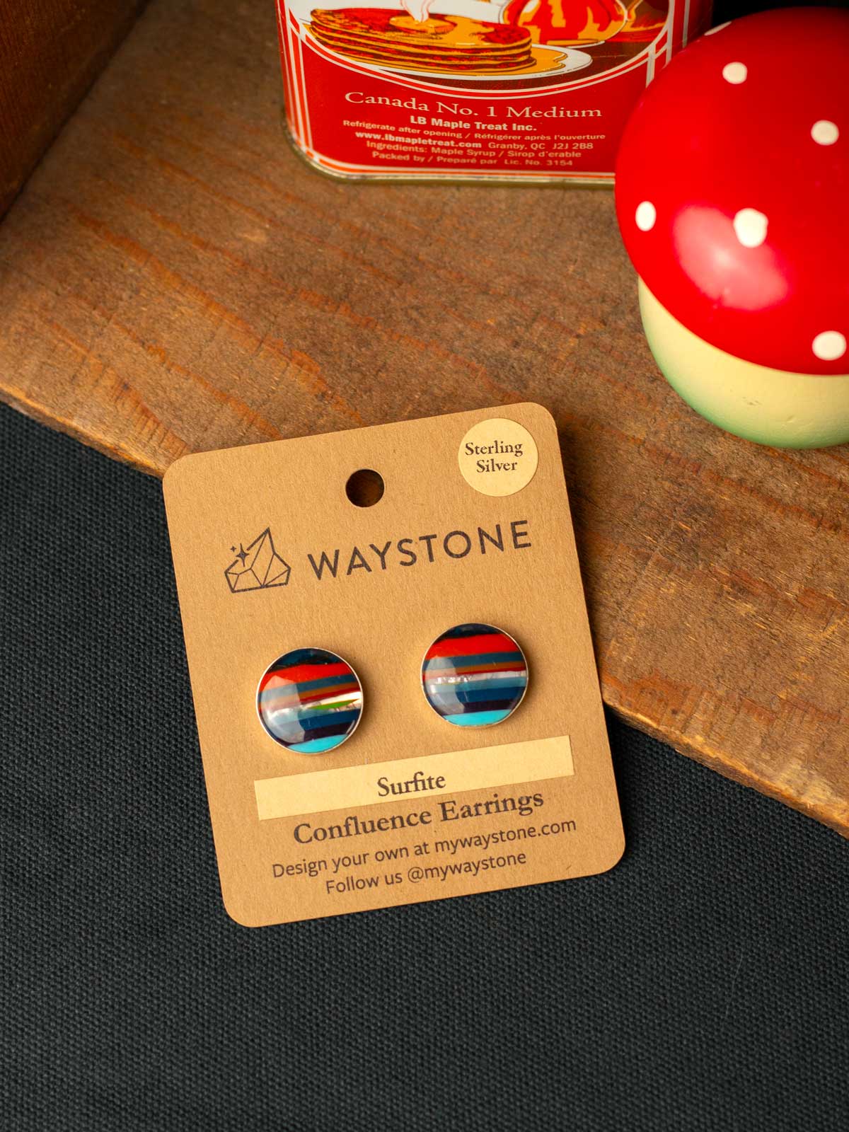 Waystone striped surfite earrings on a cardboard card