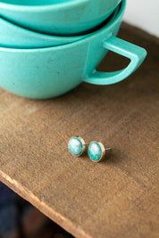 Amazonite stud earrings with a 14k gold fill setting on a wood backdrop