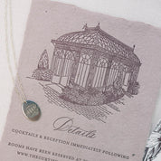An illustrated wedding invitation with a matching engraved sterling silver charm necklace