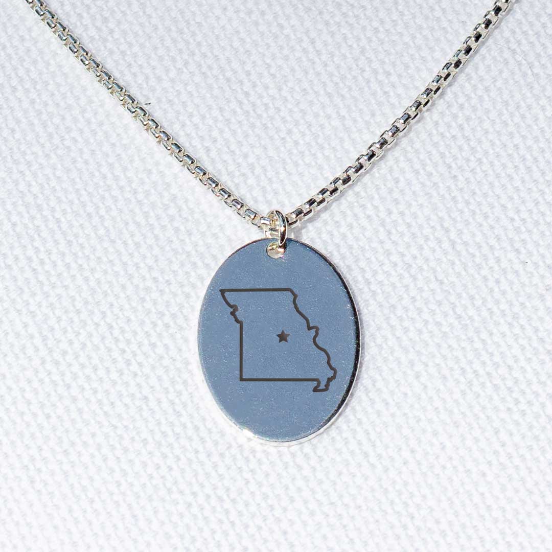 Sterling silver charm necklace on a box chain with an engraving of the state of Missouri