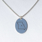 Sterling silver charm necklace on a box chain with an engraving of the state of Missouri