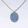 Charm necklace engraved with the shape of a US state