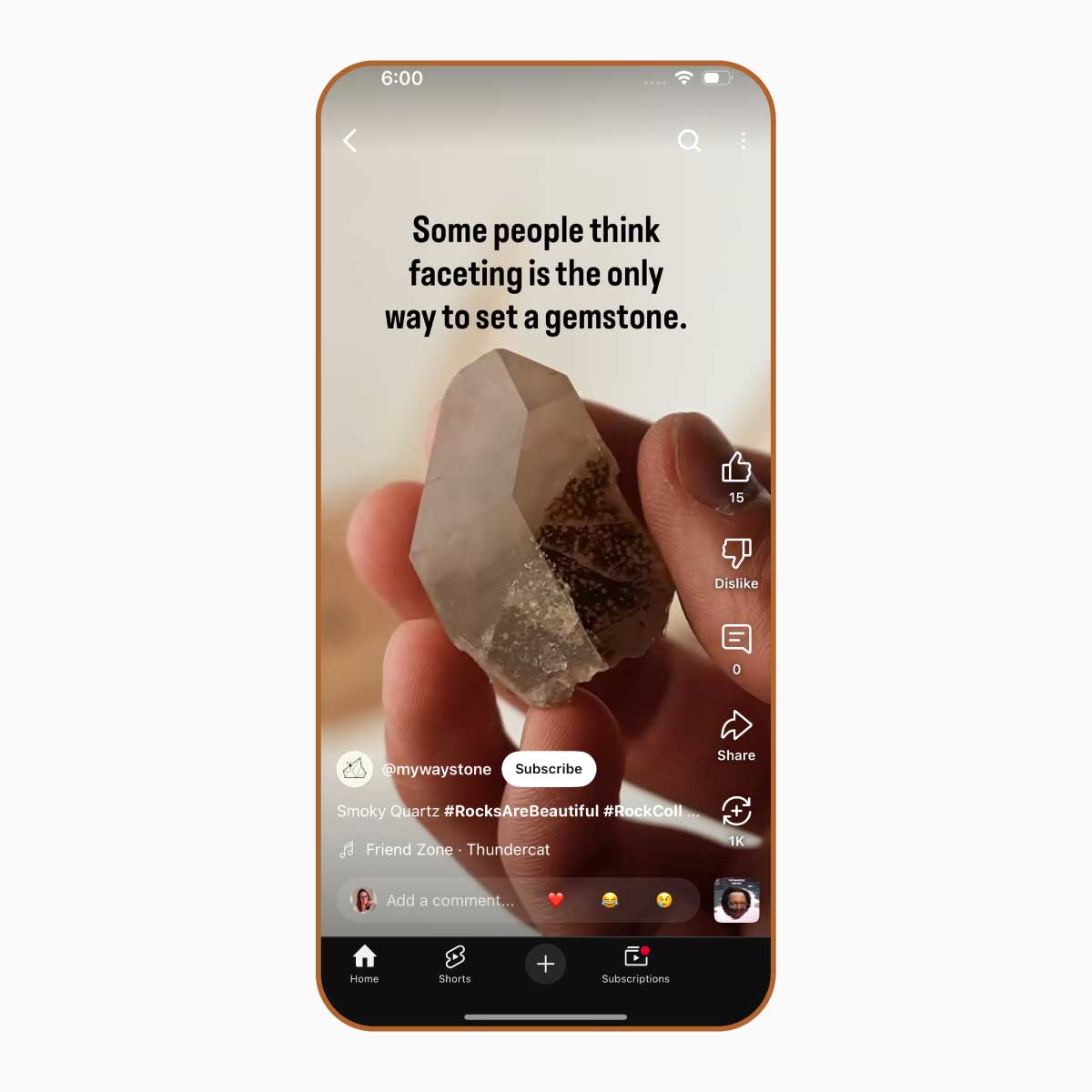 Phone screen displaying a YouTube video about turning rocks into jewelry, with a hand holding a chunk of smoky quartz.